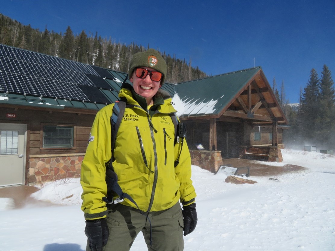 Park ranger Belen del Valle Coello outside a snow-covered park building