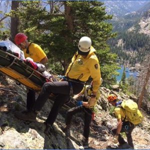 Group of people on a rocky mountain doing rescue drill