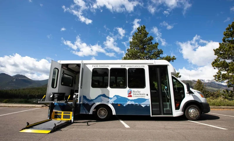 Accessible Rocky Mountain Conservancy tour bus with wheelchair lift