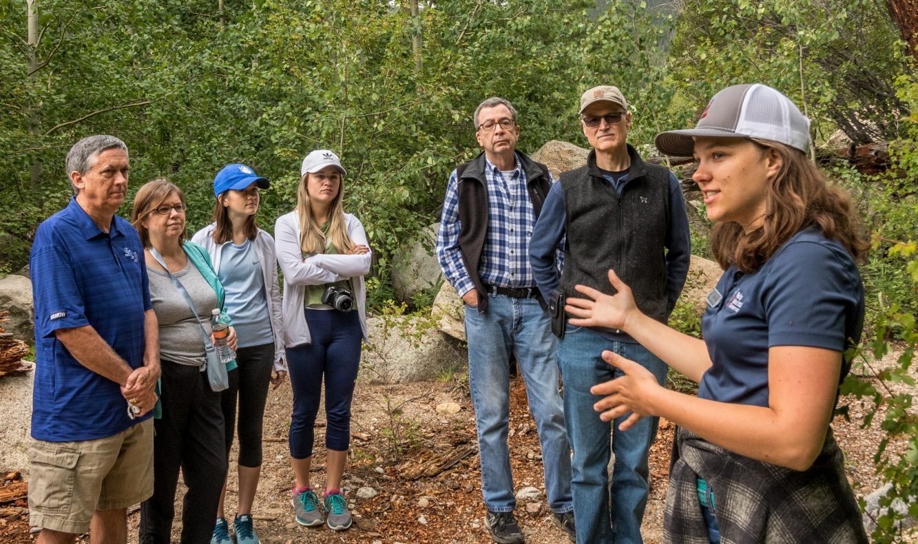 An educator speaks with a group on a trail in Rocky Mountain National Park.