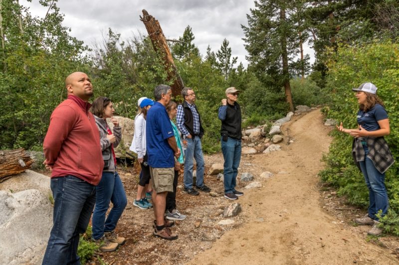 Field Institute guide speaking with a group on a forest trail