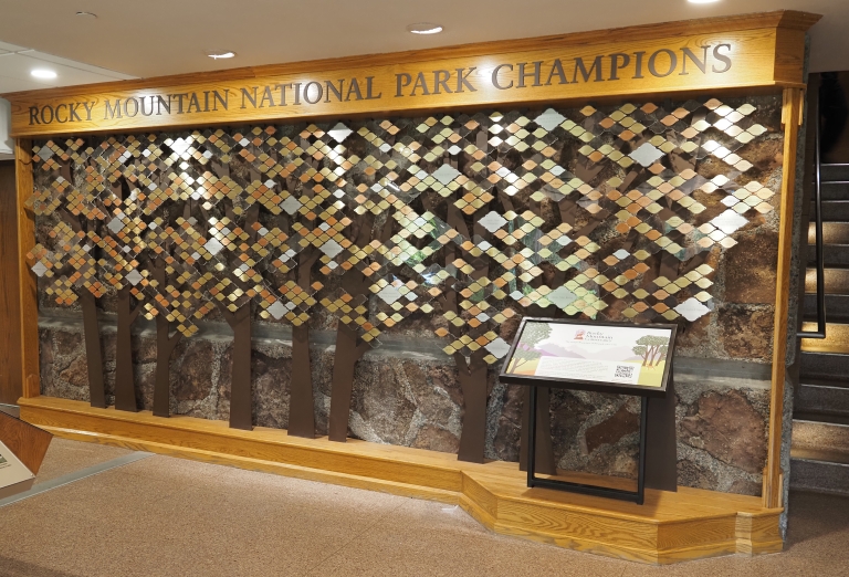 Aspen leaf tribute plaques displayed on the donor wall at Beaver Meadows Visitor Center.