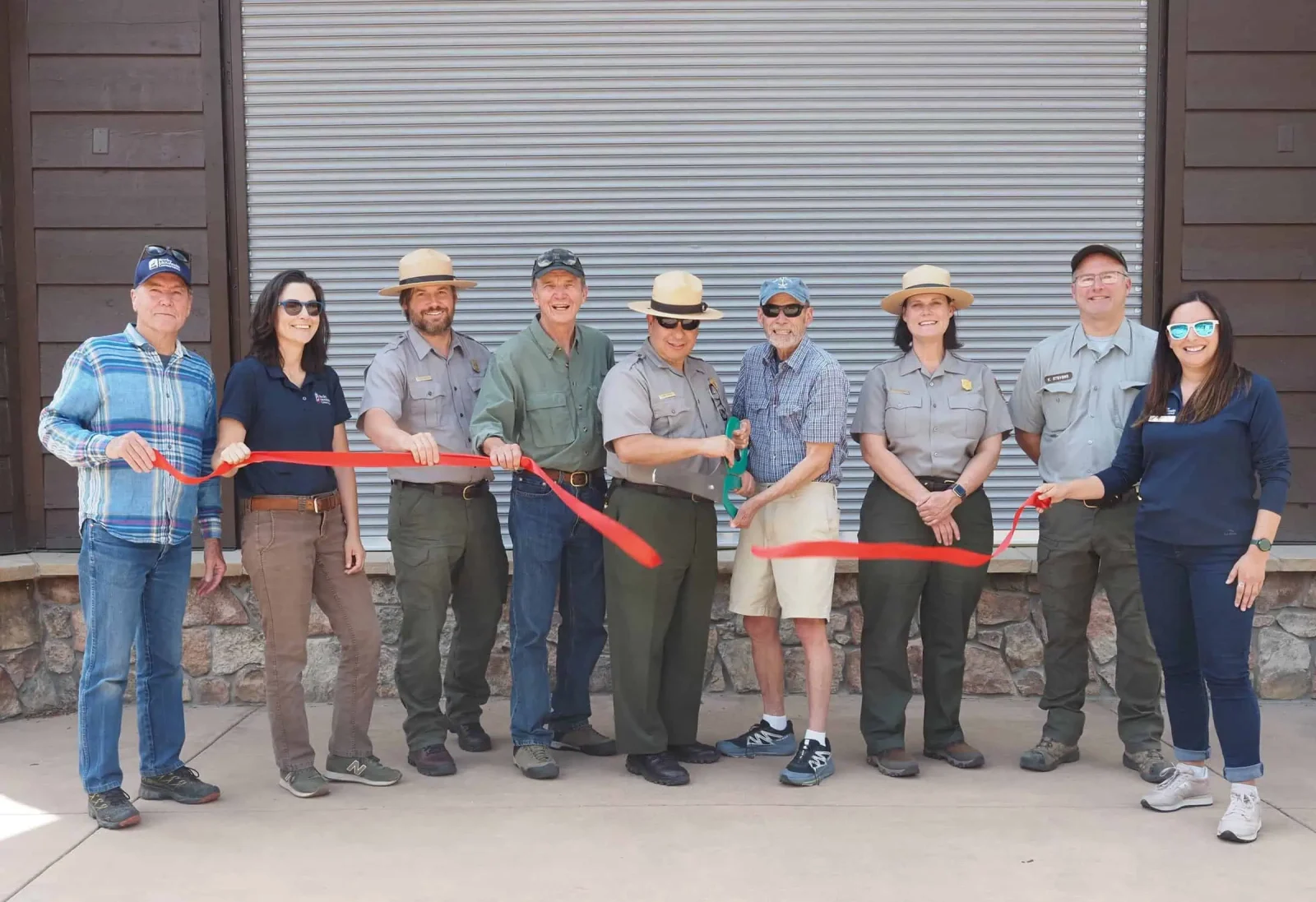 Rocky Mountain Conservancy and National Park Service representatives at a ribbon cutting