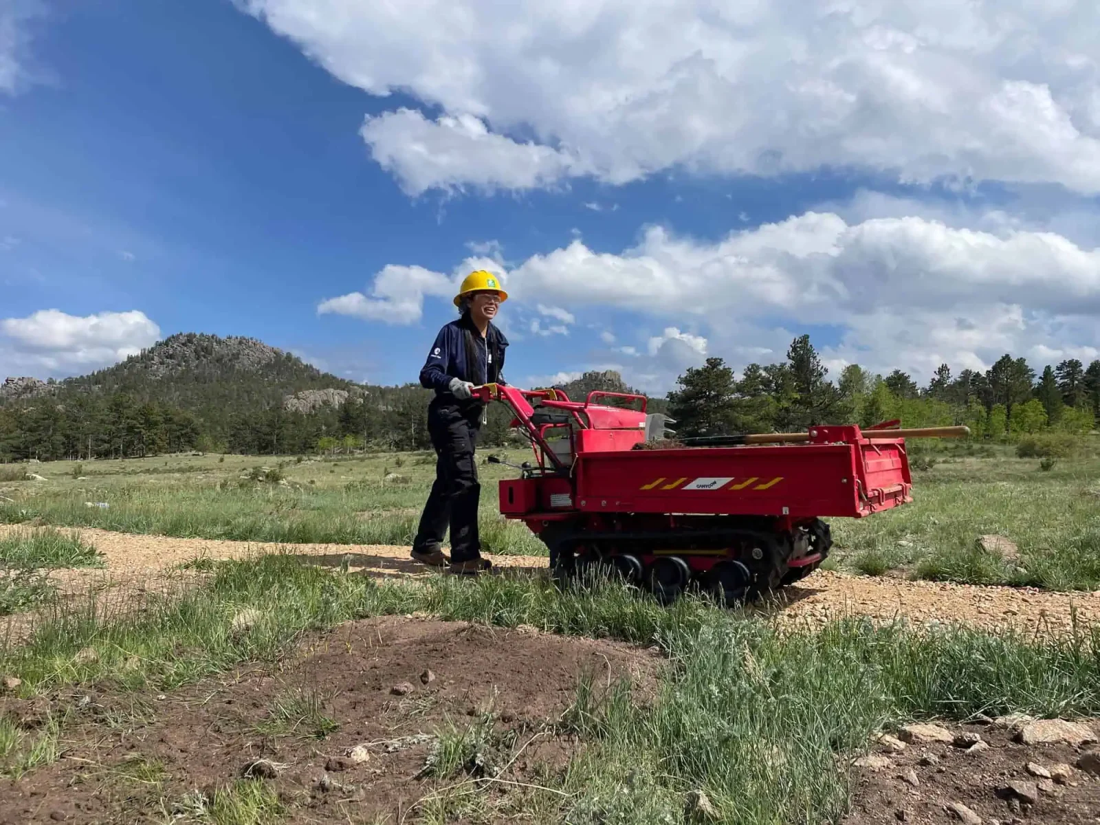 Conservation Corps crew member operating a motorized trail carrier